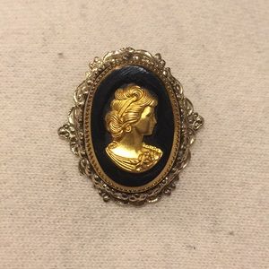 Vintage black and gold cameo brooch